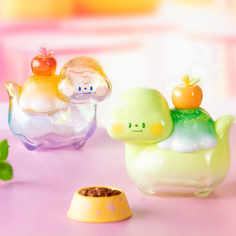 Two colorful character figurines with apple on head on a pink background
