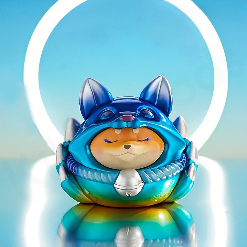 Colorful figurine of a creature with a blue hood on a reflective surface with a blue gradient background