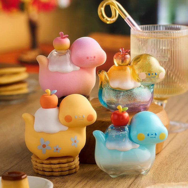 Colorful glass figurines on a wooden surface with a blurred background