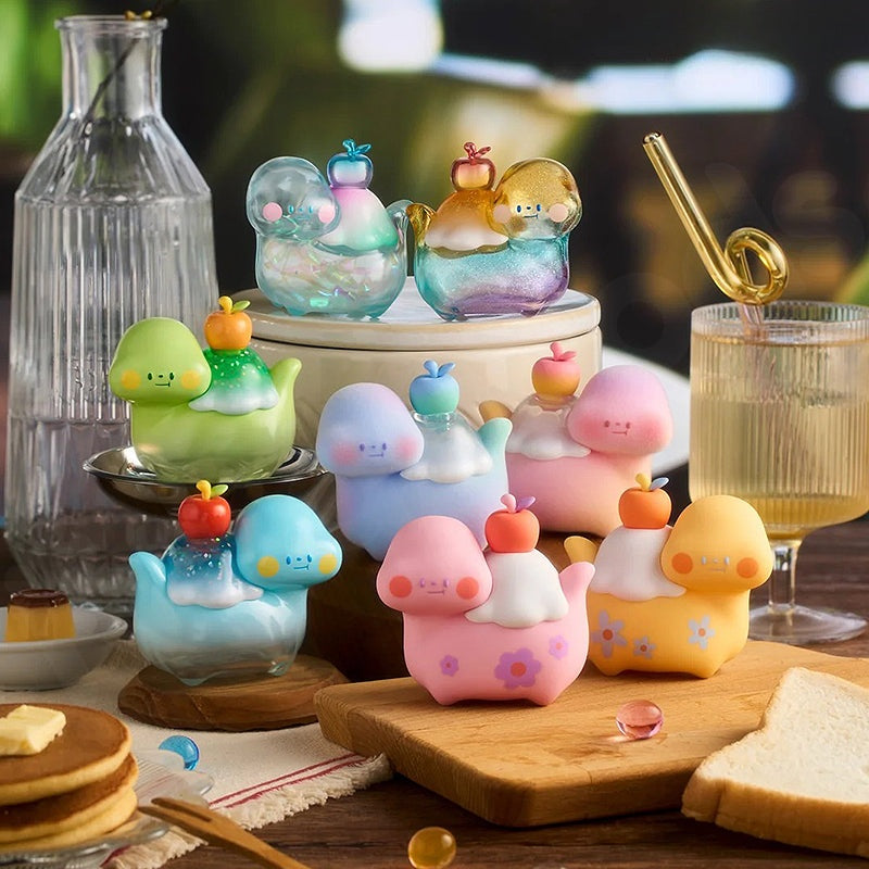Colorful toy figures resembling animals and objects on a table with food items.