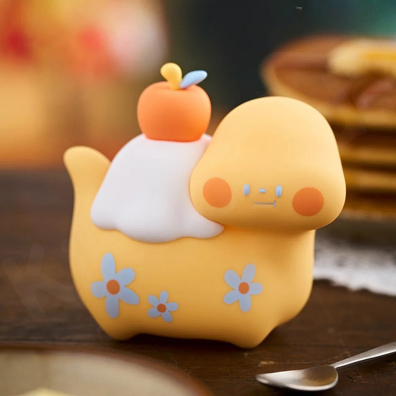 Yellow plush toy with a small boat on top, resembling a character from a children's show, on a wooden surface.