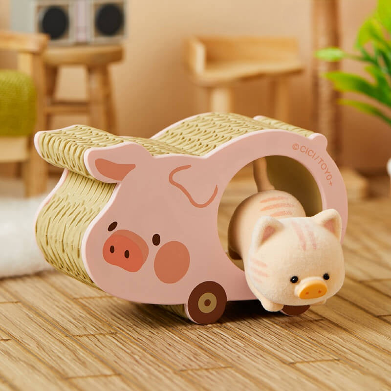 Pink pig-shaped toy with a wicker roof on a wooden floor