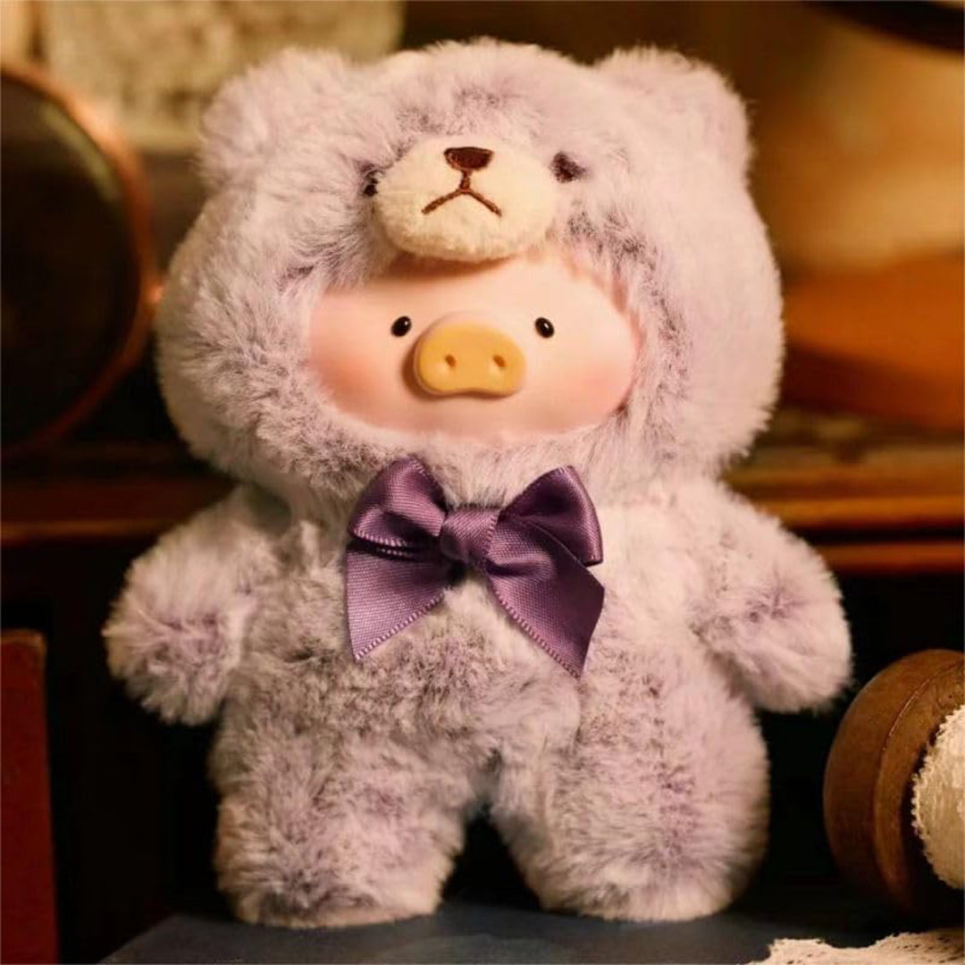 Plush toy pig wearing a lavender hood and bow tie on a blurred background