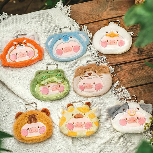 Set of plush animal keychains on a wooden surface
