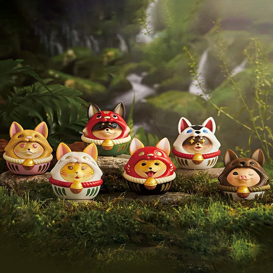 Set of fox-themed figurines with colorful hats in a forest setting