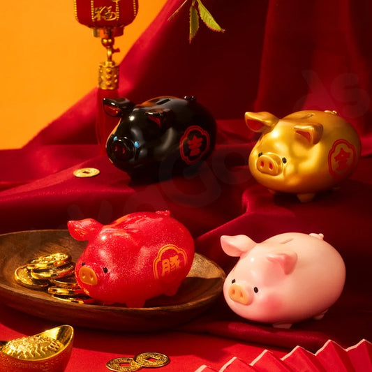 Four pig-shaped piggy banks in red, gold, black, and pink on a red background.