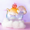 Colorful figurine with a small apple on a white cloud against a light purple background