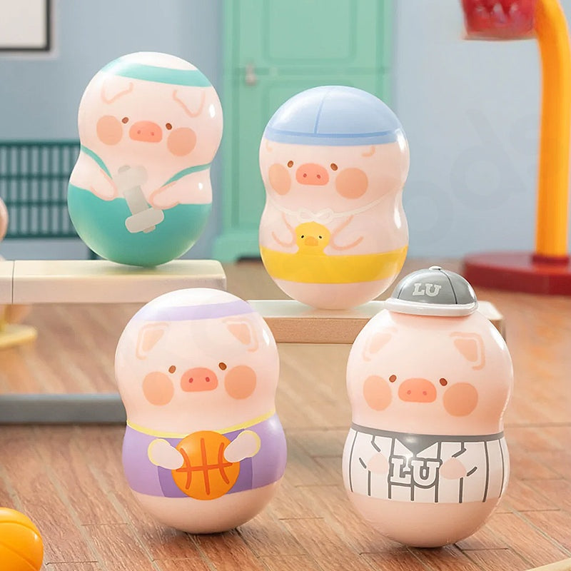 Four pig-shaped toys with different outfits on a wooden surface.