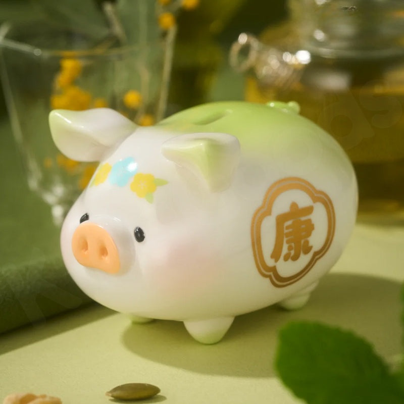 White pig-shaped ceramic money box with decorative elements on a green surface