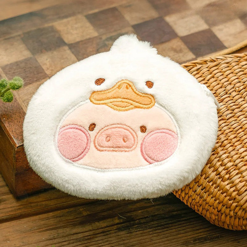 Plush toy with a pig design on a wooden surface