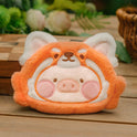 Plush toy with a pig design on a wooden surface