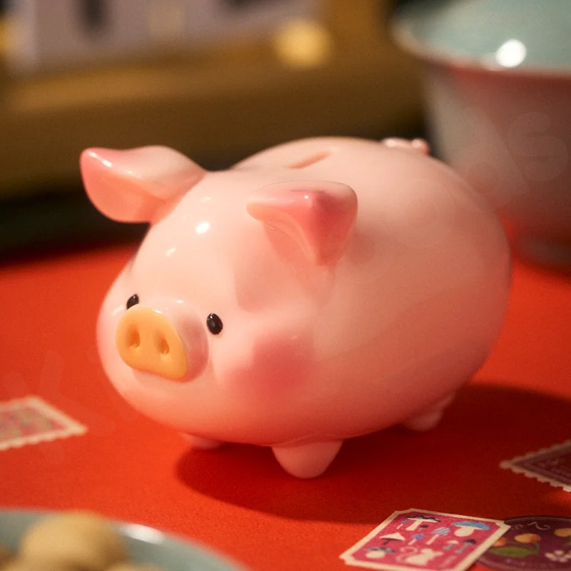 Pink piggy bank on a red surface with a blurred background
