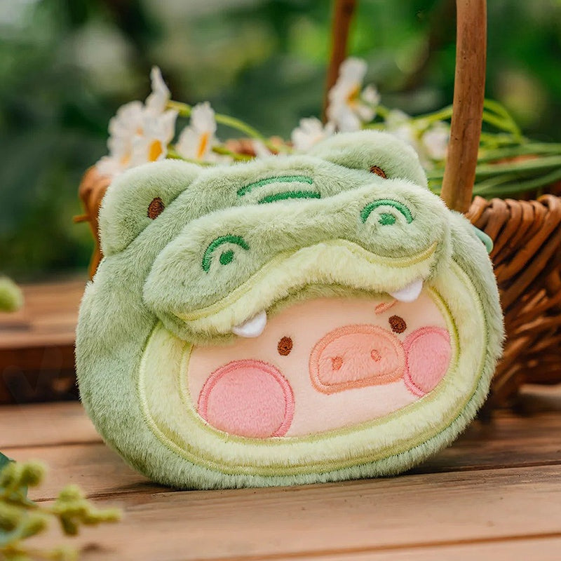 Plush toy with a green shell and pink face on a wooden surface with a blurred natural background
