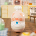 Cute pig-shaped container on a wooden surface with a blurred background