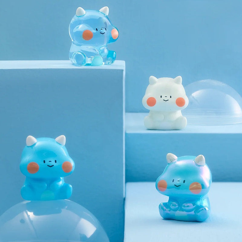 Set of four cute, colorful animal figurines on a blue background