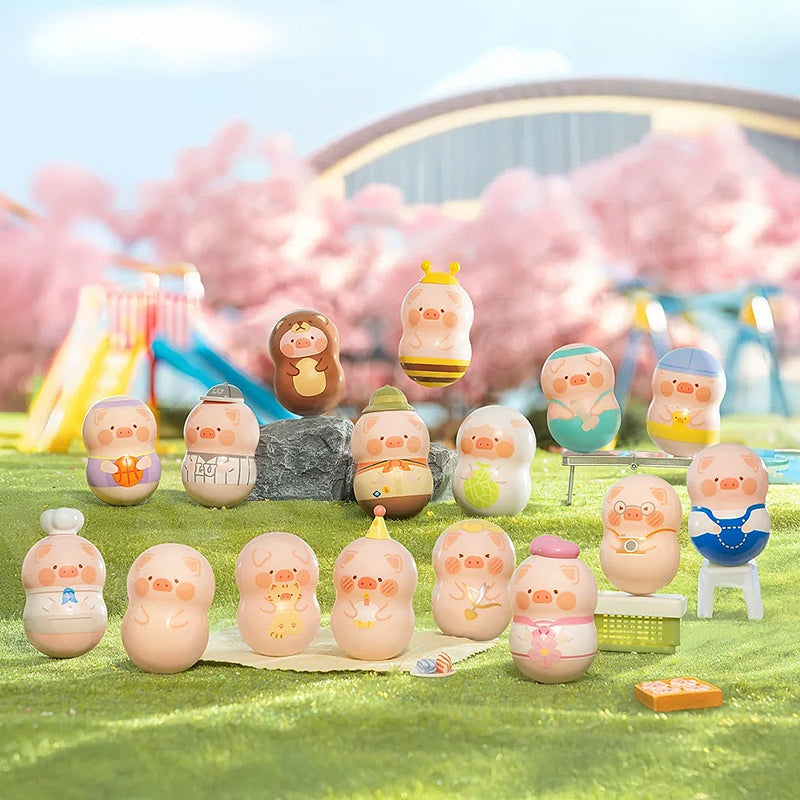 Set of small figurines on a grassy area with a blurred background