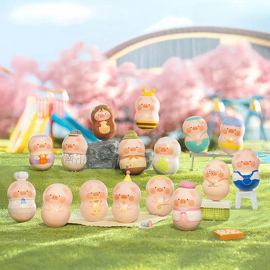 Set of small figurines on a grassy area with a blurred background