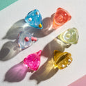 Colorful catnip toys on a light surface with shadows