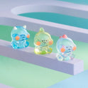 Three colorful, transparent figurines on a pastel background