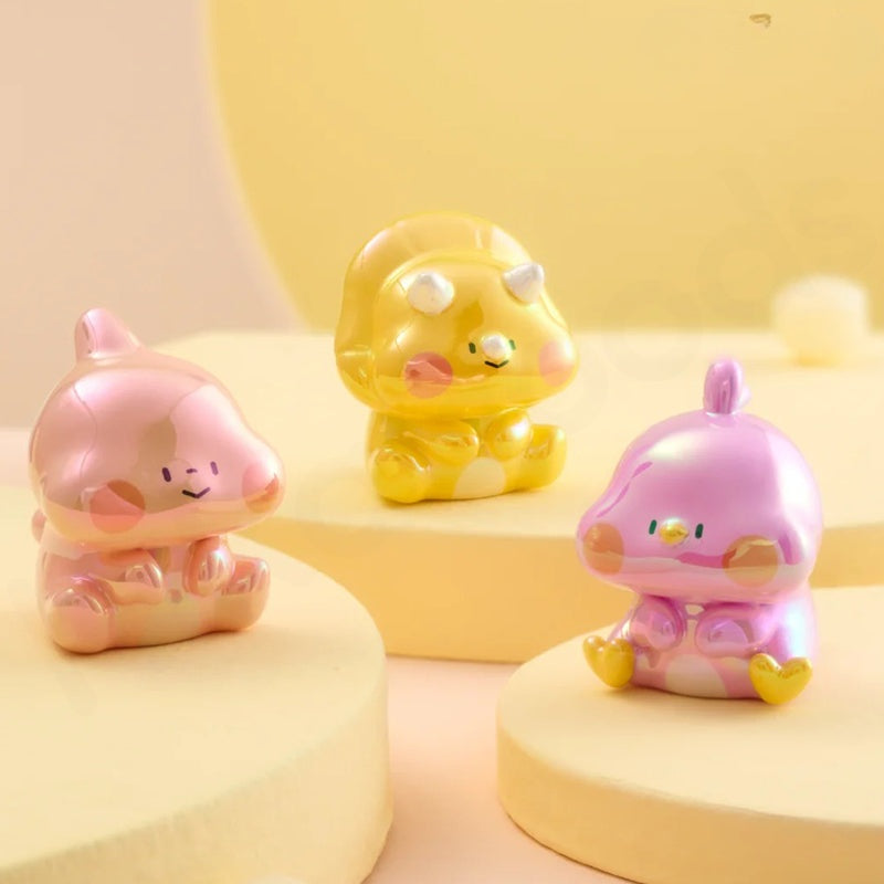 Three colorful animal-shaped figurines on a yellow background