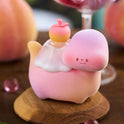 Cute pink plush toy with a small face on a wooden stand