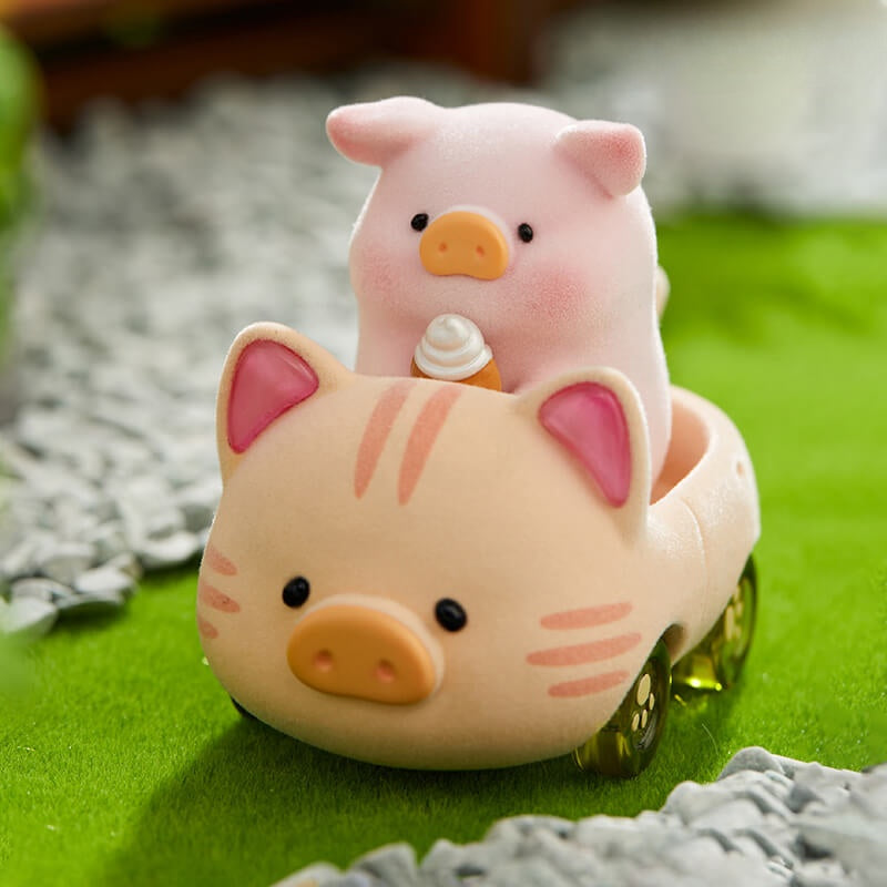 Pink piggy toy with a smaller pig figure inside on a green surface