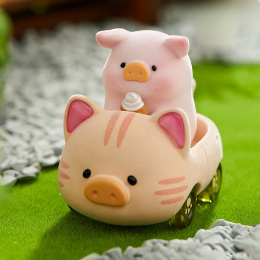 Pink piggy toy with a smaller pig figure inside on a green surface