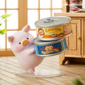 Pink piggy bank with two canned goods labeled 'Saturday' and 'Lulu the Piggy' on a wooden floor.