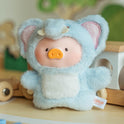 Stuffed toy in a blue bear costume with a visible brand tag on a wooden surface.