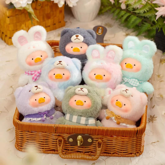 Set of small plush toys in a wicker basket on a soft surface with flowers in the background