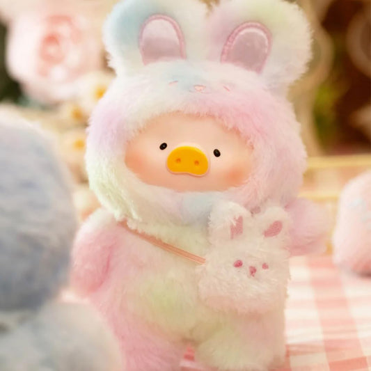 Plush toy with bunny ears and a smiling face, surrounded by soft focus background
