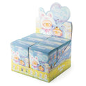 Display box of small figurines with cartoon characters on a white background
